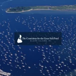 An aerial photo of the Great Salt Pond on Block Island, featuring many boats dotting the waters, and with the Committee for the Great Salt Pond's logo hovering on a layer above the photo.