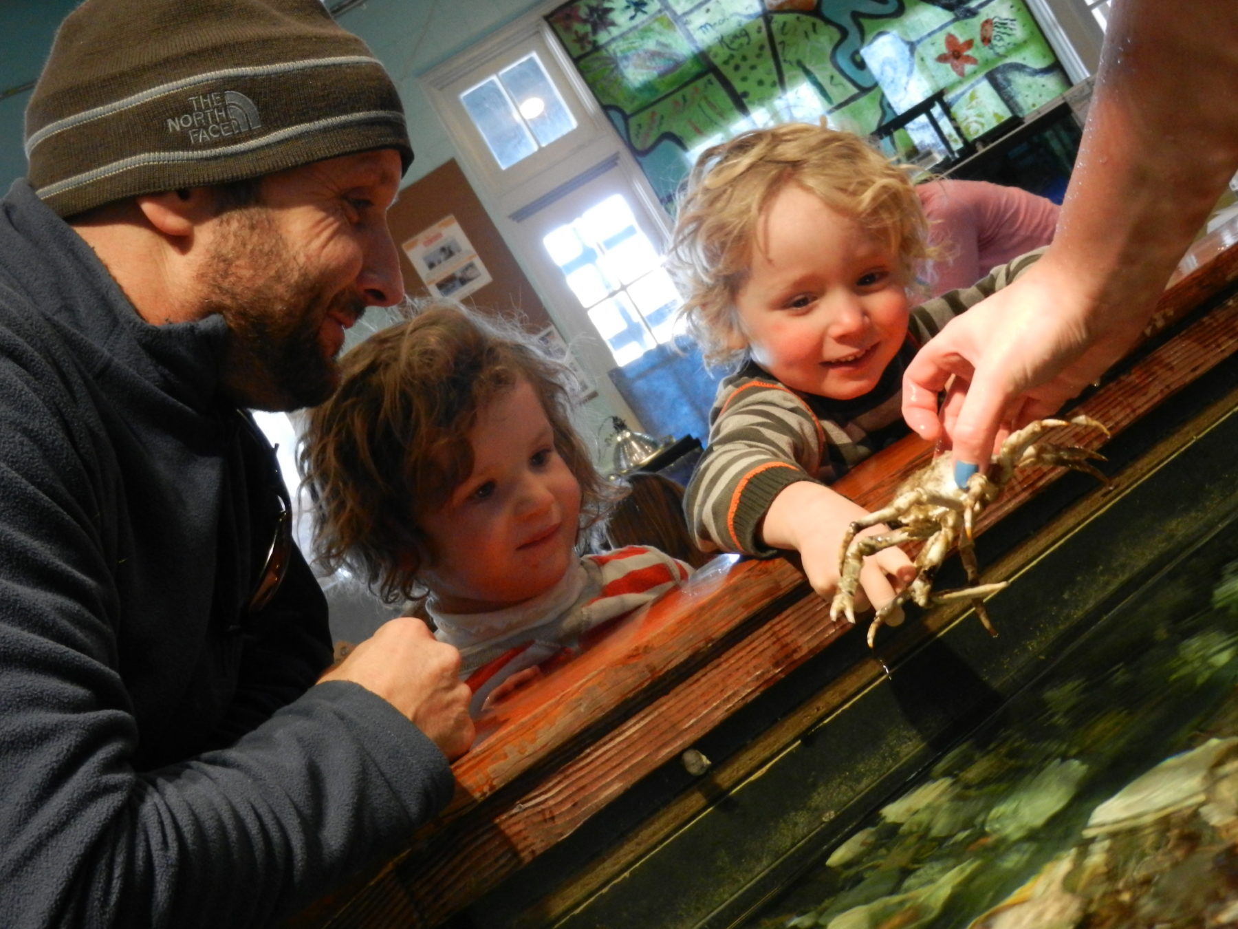 A dad and two kids at the Exploration Center and Aquarium